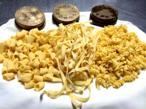 A plate of pasta and other food items.